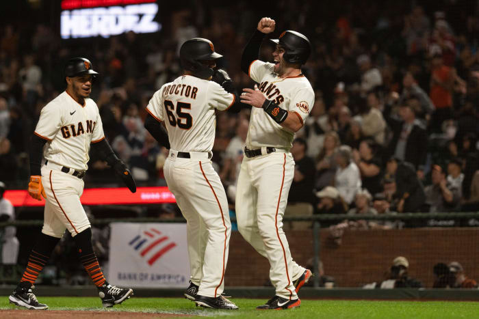 SF Giants second baseman Ford Proctor (65) celebrates with catcher Austin Wynns (14) after hitting a grand slam during the second inning against the Rockies. (2022)